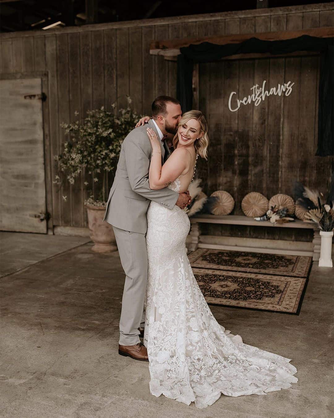 Groom hugging his wife