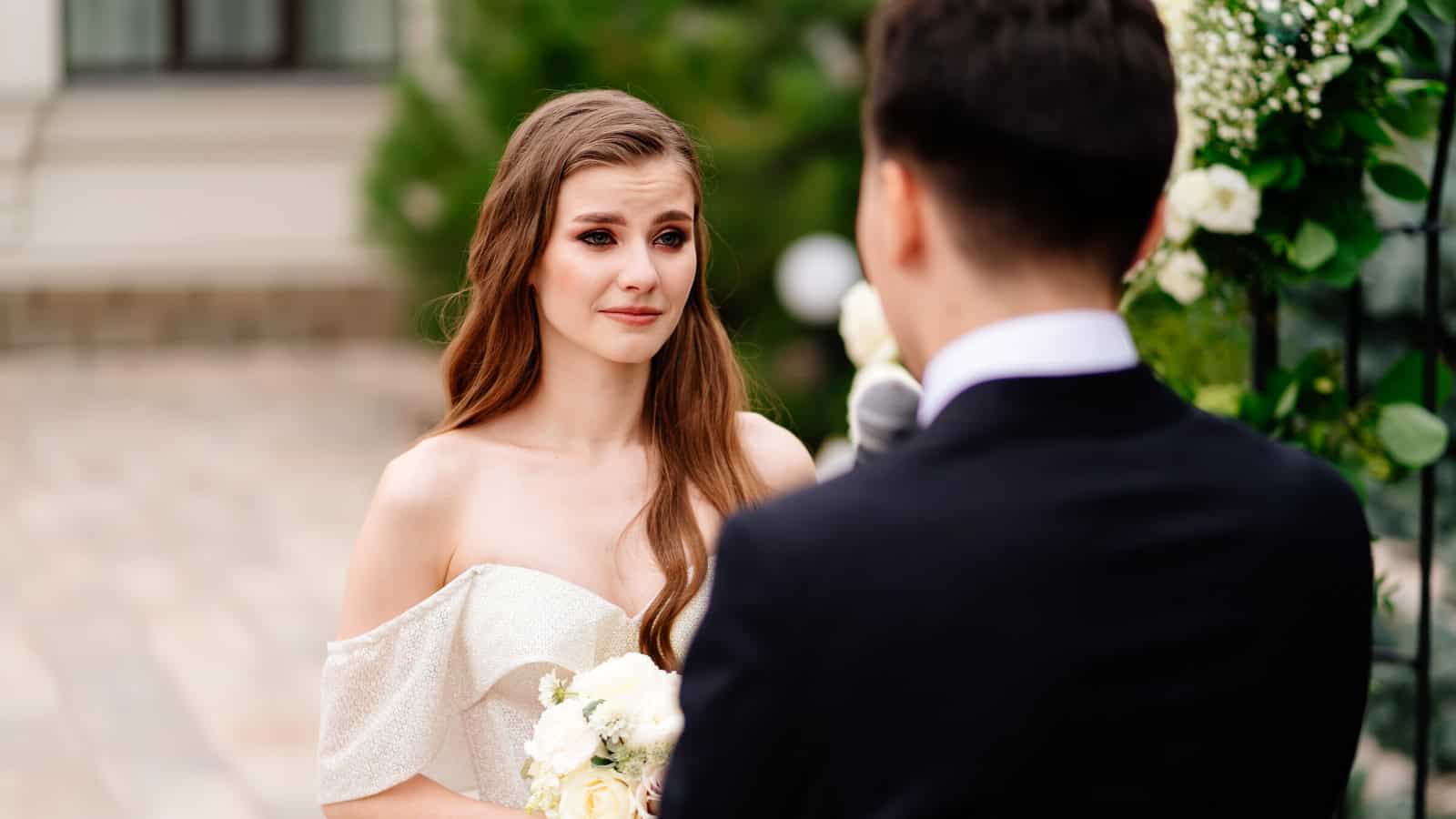 bride listens to groom's vow and cries